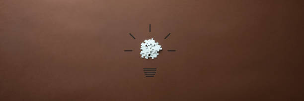 Wide view image of a light bulb made of puzzle pieces stock photo