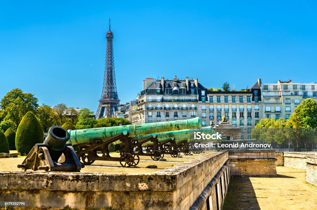 Historic cannons at Les Invalides in Paris, France Historic cannons at les Invalides with Eiffel Tower in Paris, France Ancient Stock Photo