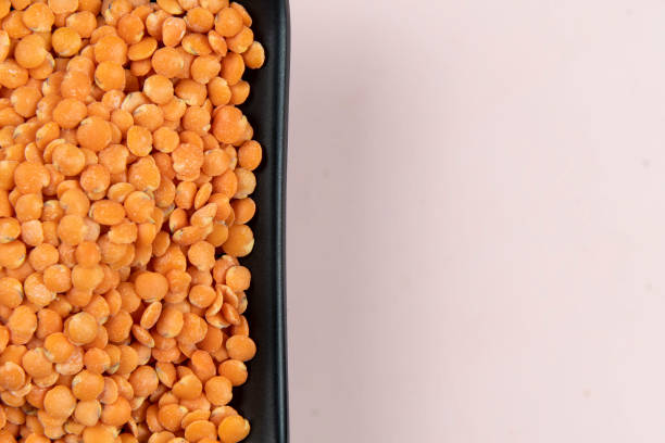 istock Red lentil in bowl isolated on pink background. Top view 1479208508