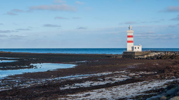 The old Garðskagi Lighthouse on Reykjanes peninsula in Iceland stock photo