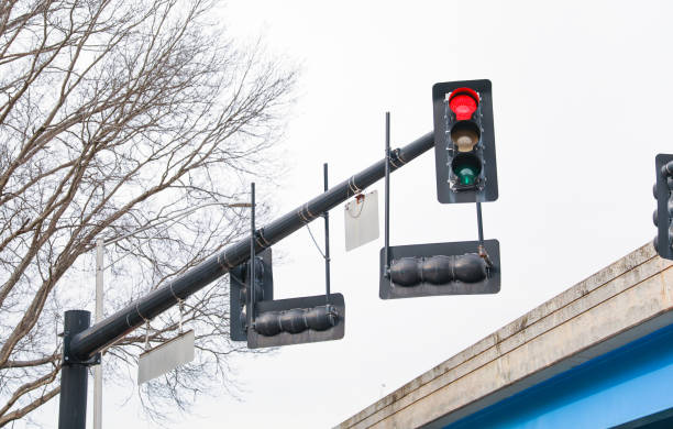 istock Busy intersection at night with illuminated stop lights: red for stop, green for go, and yellow for prepare to stop. Emphasizes traffic regulation 1479214923