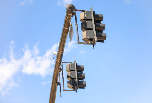 istock Busy intersection at night with illuminated stop lights: red for stop, green for go, and yellow for prepare to stop. Emphasizes traffic regulation 1479214956