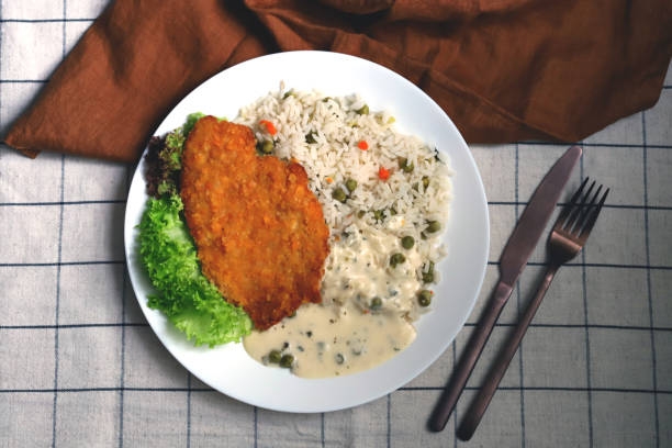 istock Rice with vegetables and chicken schnitzel. Healthy lunch or dinner on a plate. 1479215042