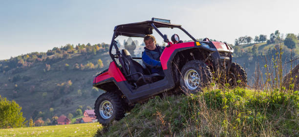 istock A man driving a quad ATV motorcycle through beautiful meadow landscapes 1479228330