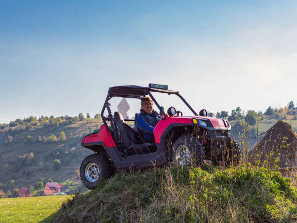istock A man driving a quad ATV motorcycle through beautiful meadow landscapes 1479228917