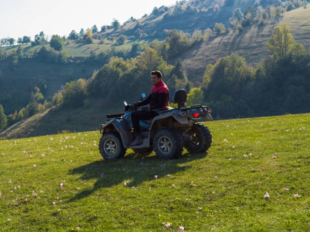istock A man driving a quad ATV motorcycle through beautiful meadow landscapes 1479232685