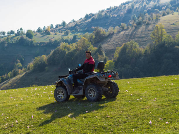 istock A man driving a quad ATV motorcycle through beautiful meadow landscapes 1479233984