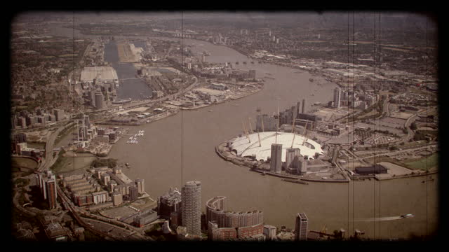 Old Film Aerial View of City Airport London and Canary Wharf, UK. 4K