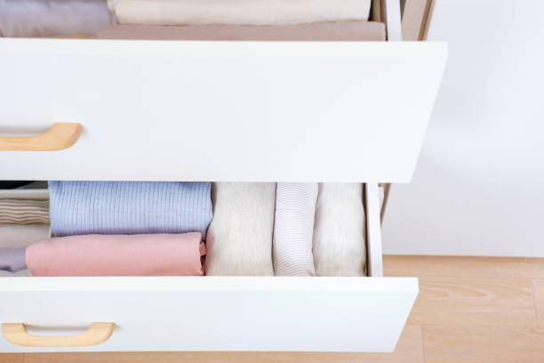 istock Clothes folded in a box in a dresser close-up, space organization concept. 1479238575