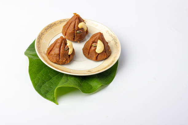 istock Home made traditional indian modak sweets on white background and plate 1479242982