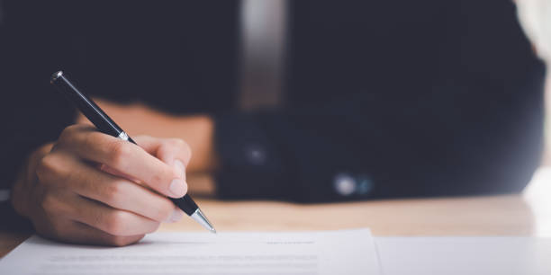 istock businessman signing documents ,Signing a form ,validates and manages business documents and agreements ,signing a business contract approval ,employment idea, project review Business paperwork 1479247663