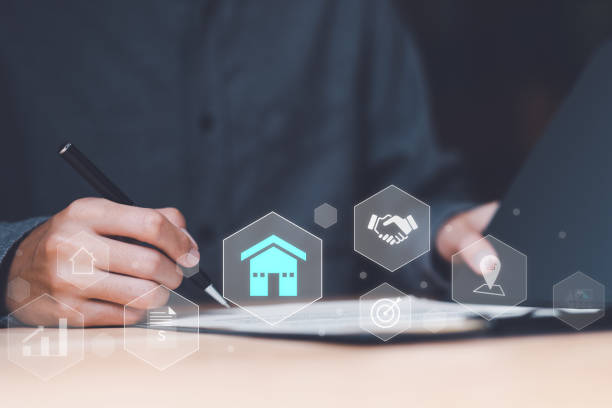 istock Real estate agents handle documents and contracts for clients ,Investment loan approval concepts to build residential homes , real estate business ,appraisal of property value ,home loan contract 1479247696