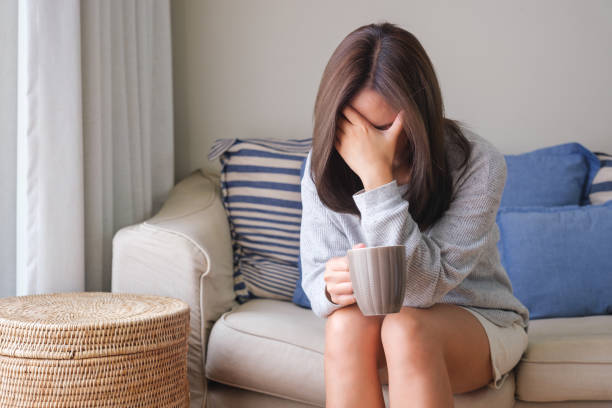 istock A young woman feeling sad and stressed, sick and headache at home 1479258285