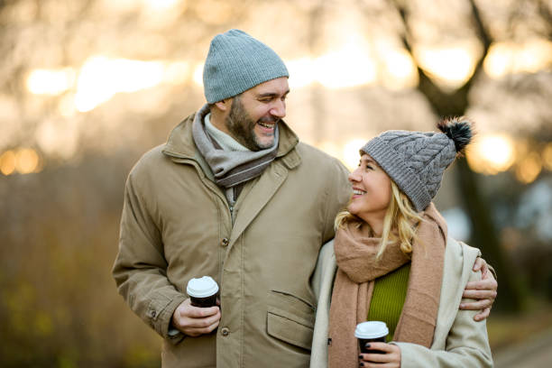 istock A happy romantic couple with coffee walking in the park 1479263310