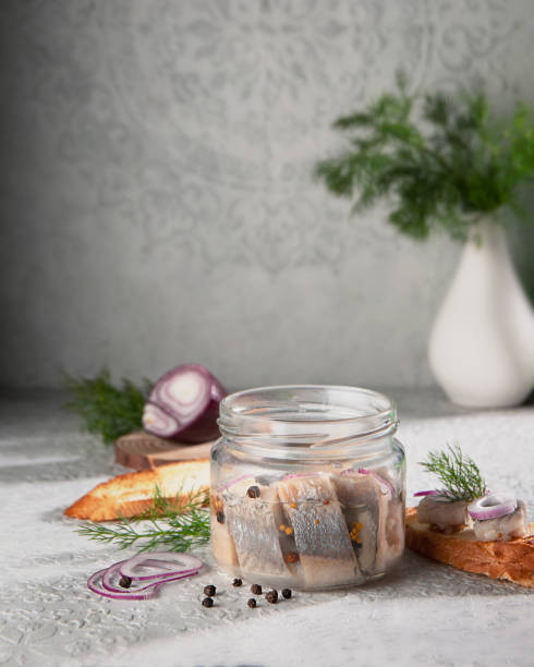 istock Herring lying in a jar with butter, onion andpepper. 1479263342