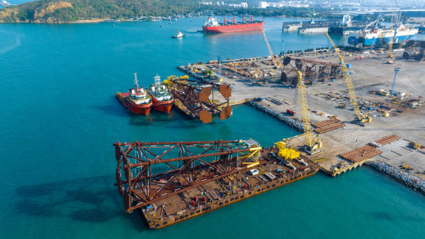 istock Tug boat Draging cargo container ship to dry dock concept maintenance service working in the sea. Insurance and Maintenance Cargo Ship concept. Freight Service maintenance Insurance 1479264661