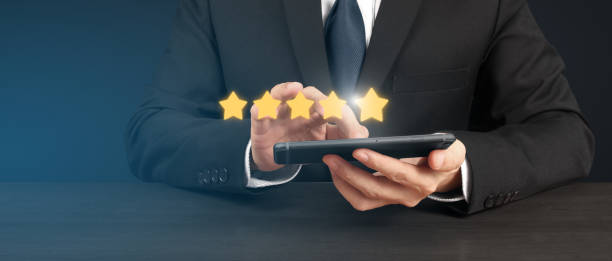 istock Man holding smartphone device and touching screen with five star rating feedback 1479267504