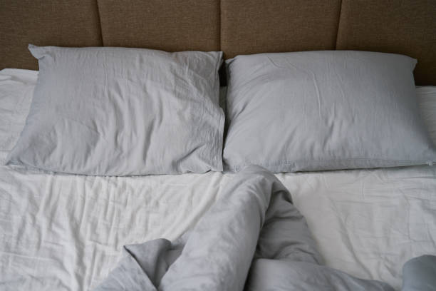 istock Crumpled bed with pillows, blanket and crumpled sheets in bedroom 1479275297