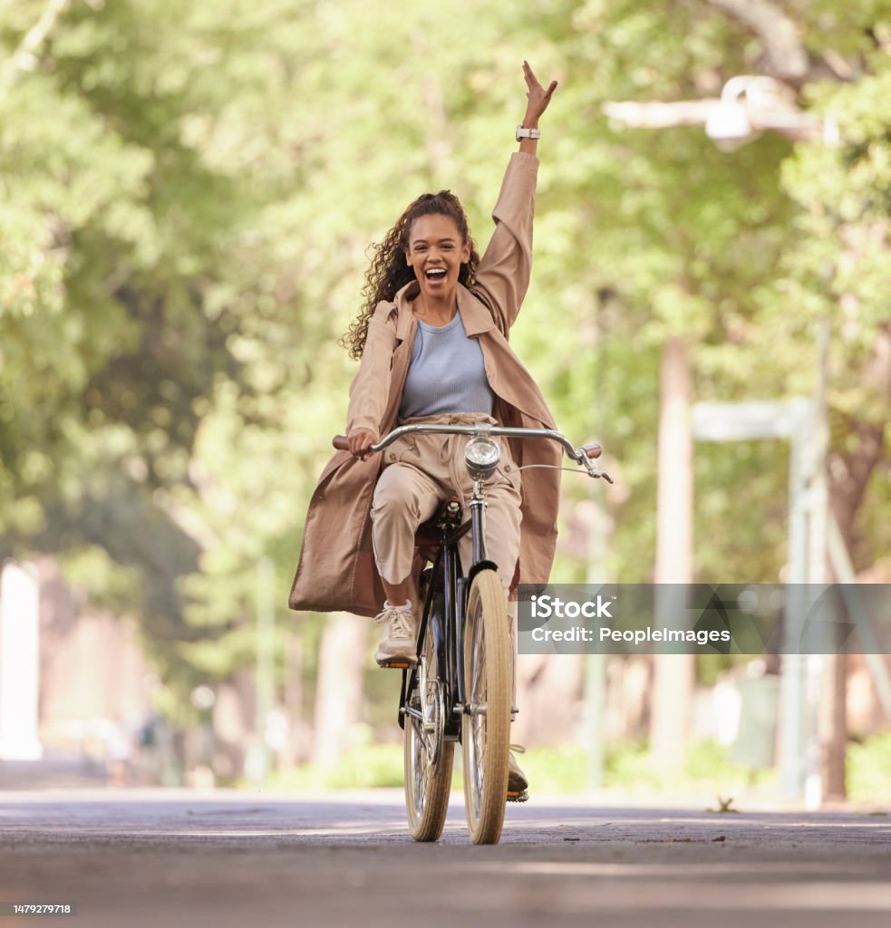 Happy black woman, bike and cycling in the park for fun holiday break, weekend or travel in the outdoors. African American female smiling in happiness and enjoying bicycle ride, traveling or freedom Cycling Stock Photo
