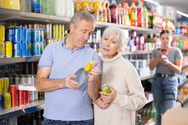 istock Aged woman and man choosing soft drinks in grocery store 1479280831
