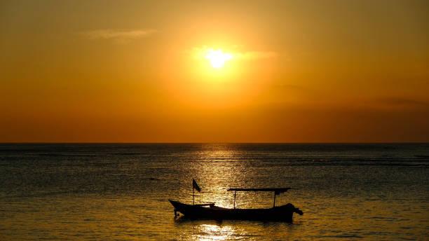 istock Fishing boat at golden sunset momen 1479281092