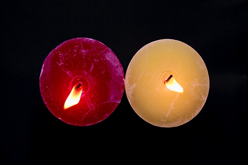 Abstract of two candles burning on black background