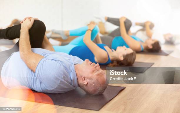 Elderly Man Doing Glutes Stretching Exercises At Training In Gym Stock Photo - Download Image Now