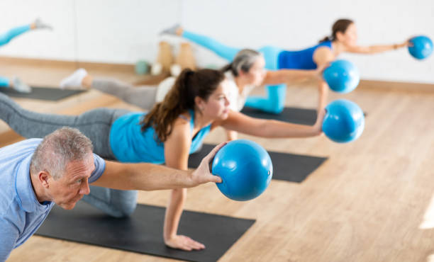 istock Elderly man practicing pilates with ball in gym area 1479284114