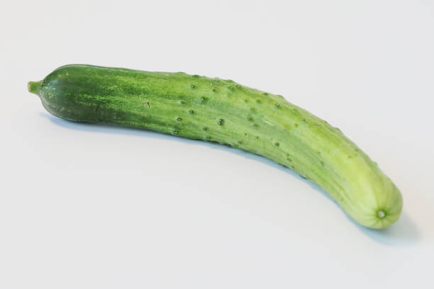 A curved chinese cucumber isolated on a white background
