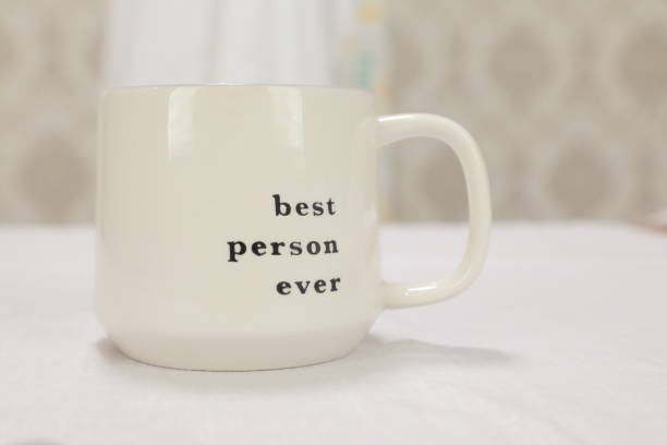 istock A white cup that says best person ever on it. 1479286071