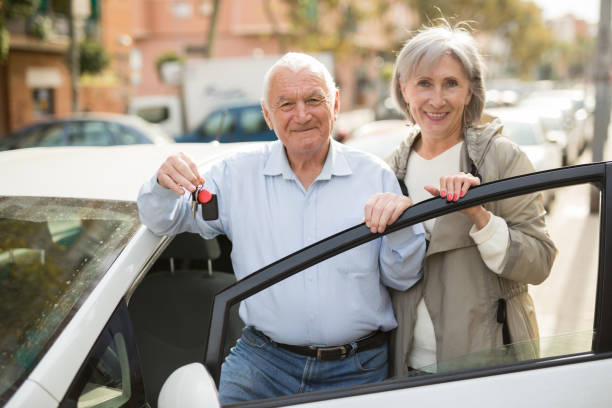 istock Senior couple standing beside car 1479287029