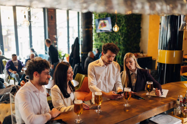istock Four entrepreneurs are hanging out in a pub, drinking beer, chatting 1479288006