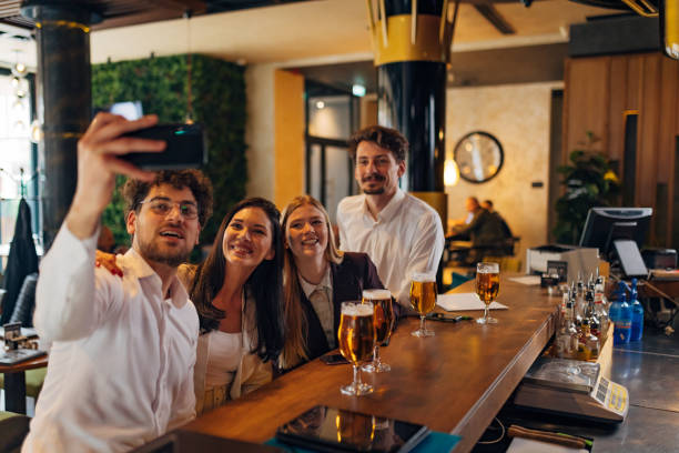 istock Four business people taking selfie at bar after work 1479288483