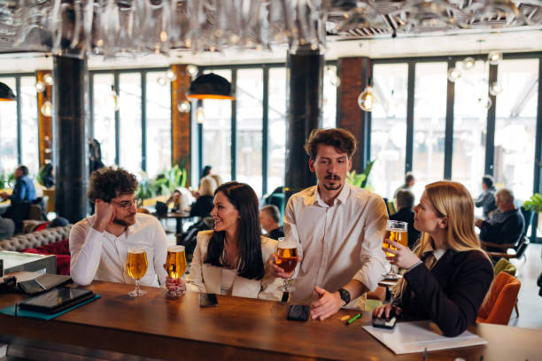 istock Four cheerful entrepreneurs are hanging out in a pub, drinking beer, chatting 1479288750