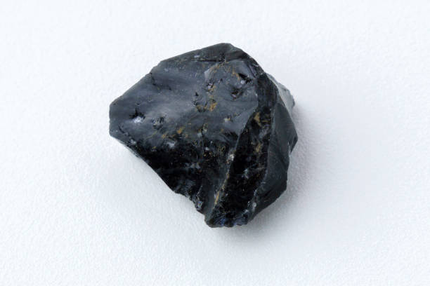 istock Black Obsidian stone on a white background. Natural glass. Black mineral gem 1479290182