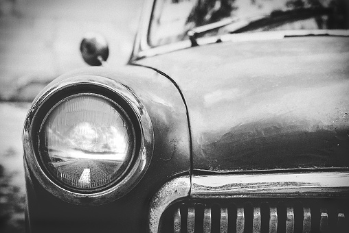 vintage cars abandoned and rusting away in rural wyoming, black and white photo