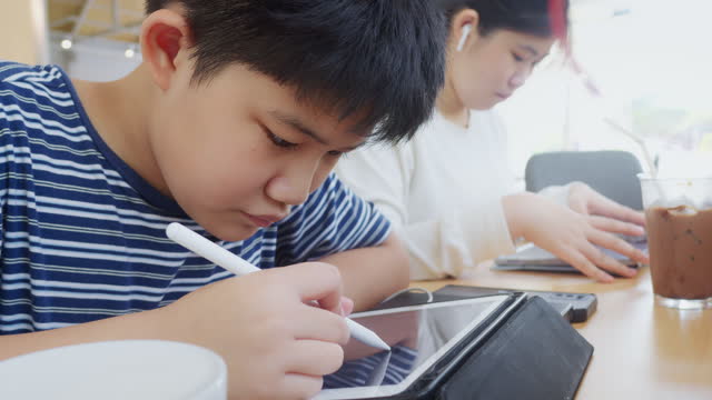 Lifestyles asian boy learning drawing tablet