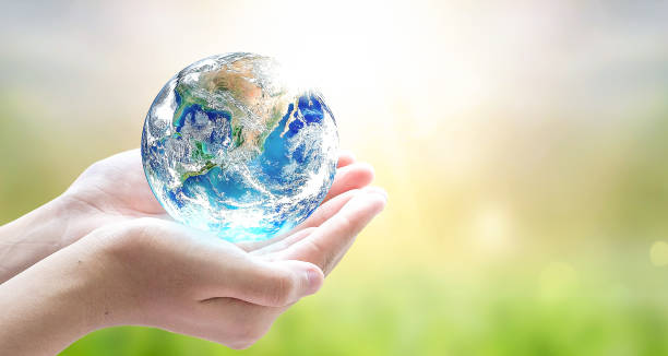 istock Earth Day,  Human hands holding earth global on blurred nature background. Elements of this image furnished by NASA 1479299975