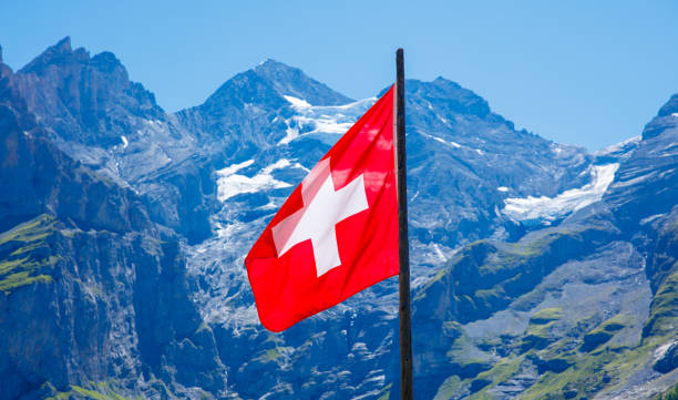 istock Red swiss flag in mountain in the background 1479300948