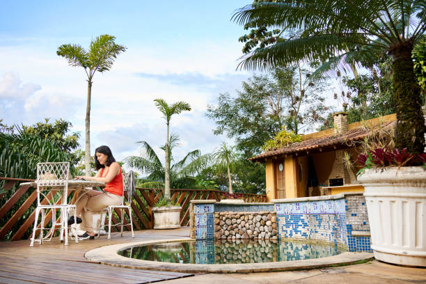 istock Young woman working by the poolside at her staycation villa 1479300984
