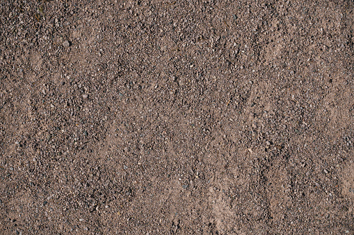 Dark brown gravel background. Common city textures