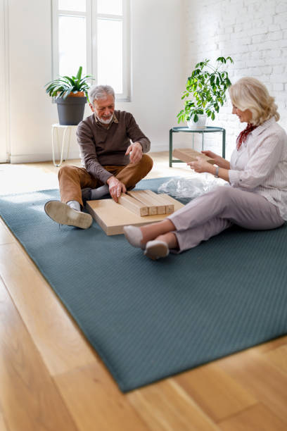 istock A happy senior couple is assembling a new table in a new home. 1479301367