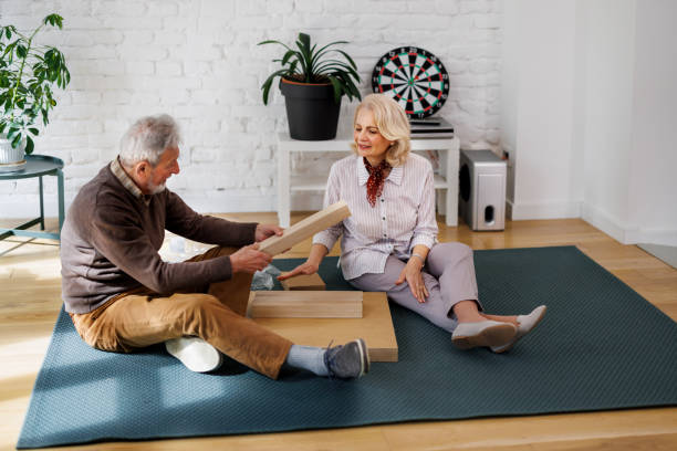 istock A happy senior couple is assembling a new table in a new home. 1479301537