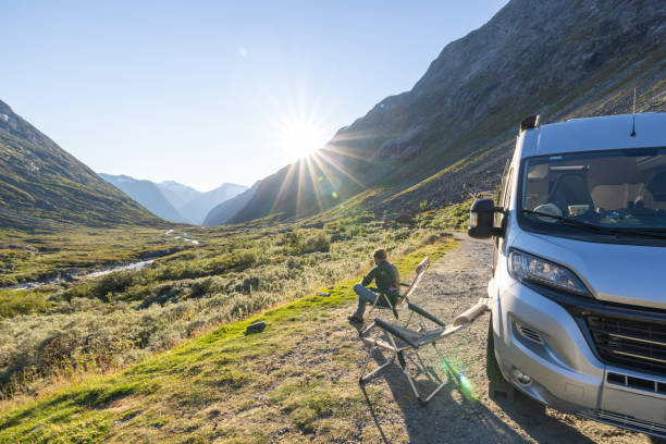istock Man relaxing near camper van at sunset, van life concept 1479302889