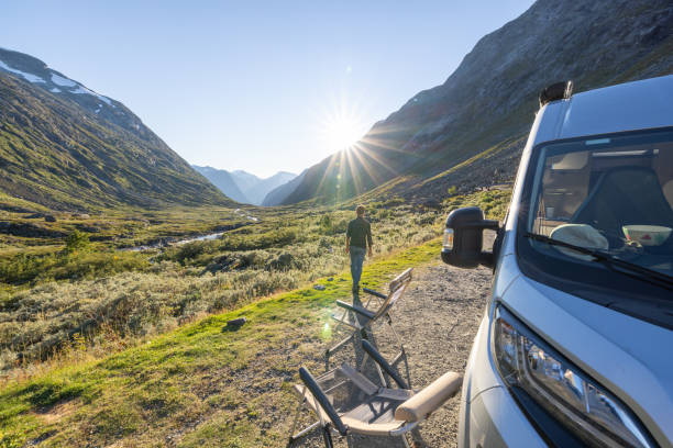 istock Man relaxing near camper van at sunset, van life concept 1479302892