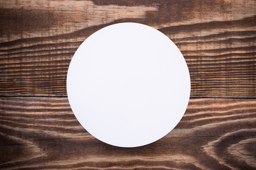 Wooden background with a white circle in the middle