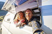 Couple in a van taking a selfie, van life concept