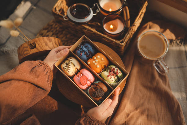 istock Box with different assortment of macaroons in hands 1479309211