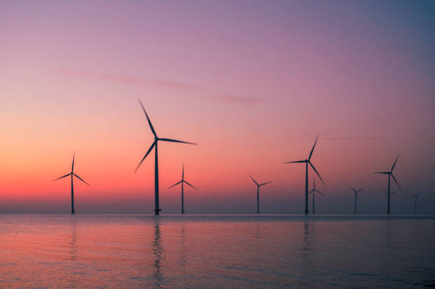 istock Wind turbines in an offshore wind park producing electricity during sunset. 1479310125