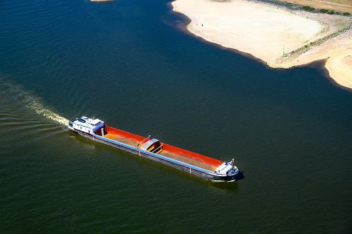 Ships passing Düsseldorf on the river Rhine with an exceptional low water level during a long period of drought in the summer of 2022.